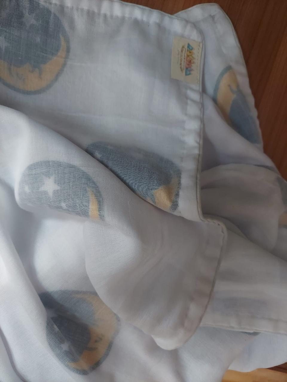 Muslin cloth printed with soft grey moons and stars